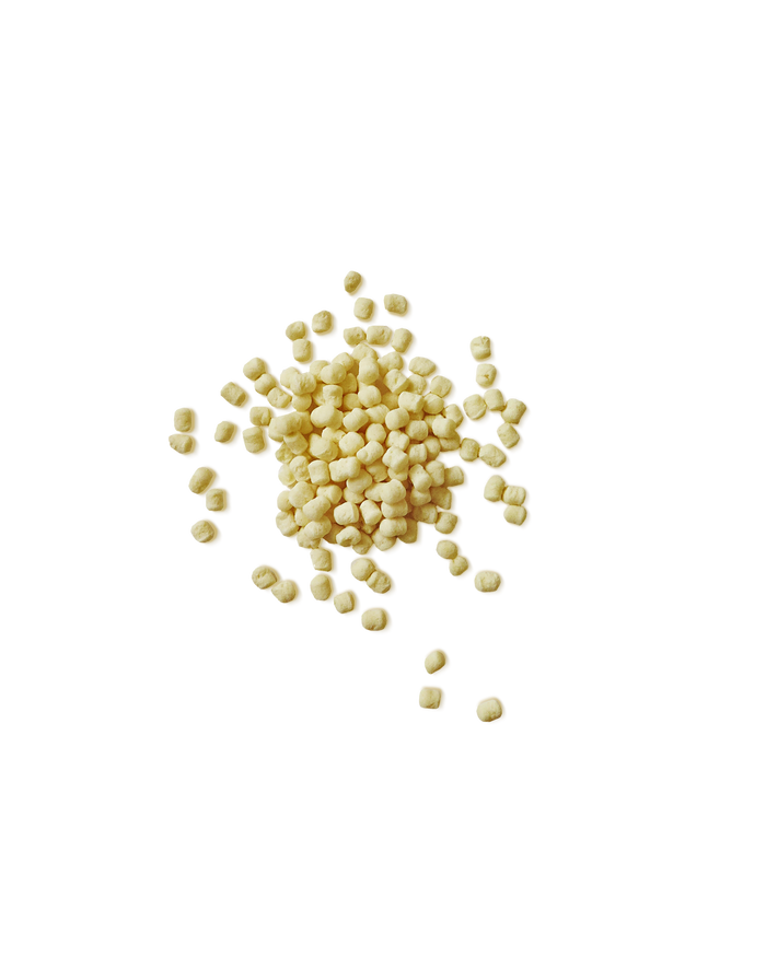 A small pile of PROMIX Whey Protein Puffs, the pale round pieces the bar is built from.